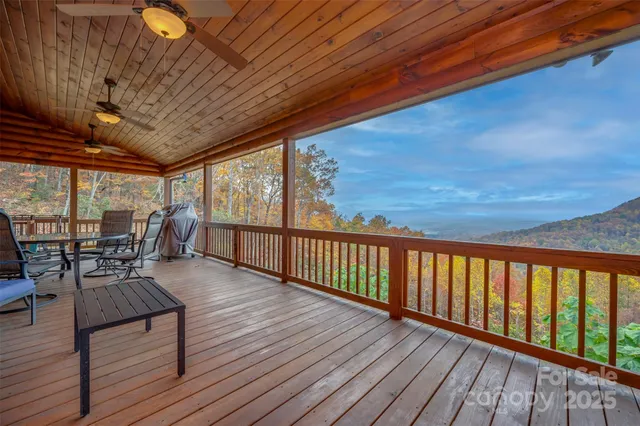 a living room with furniture a flat screen tv and kitchen view