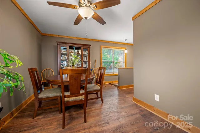 a dining room with furniture a window and wooden floor