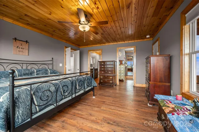 a large room with furniture wooden floor and chandelier