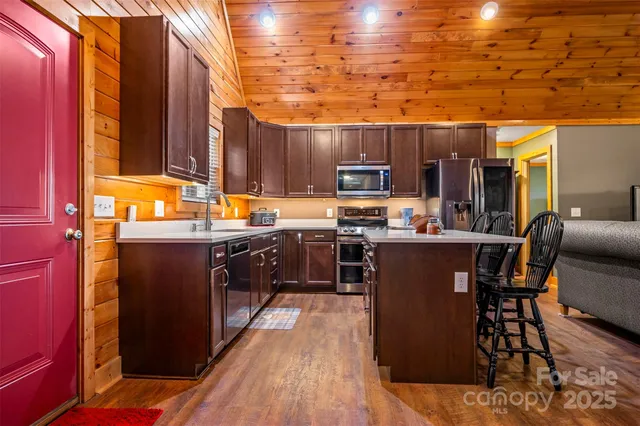 a kitchen with stainless steel appliances a stove sink microwave and cabinets