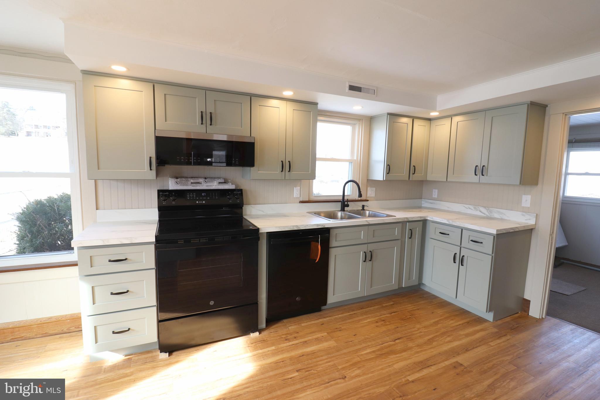 985 South Ridge Road Denver, PA 17517 - Photo 6 of 36 a kitchen with a sink stove and refrigerator
