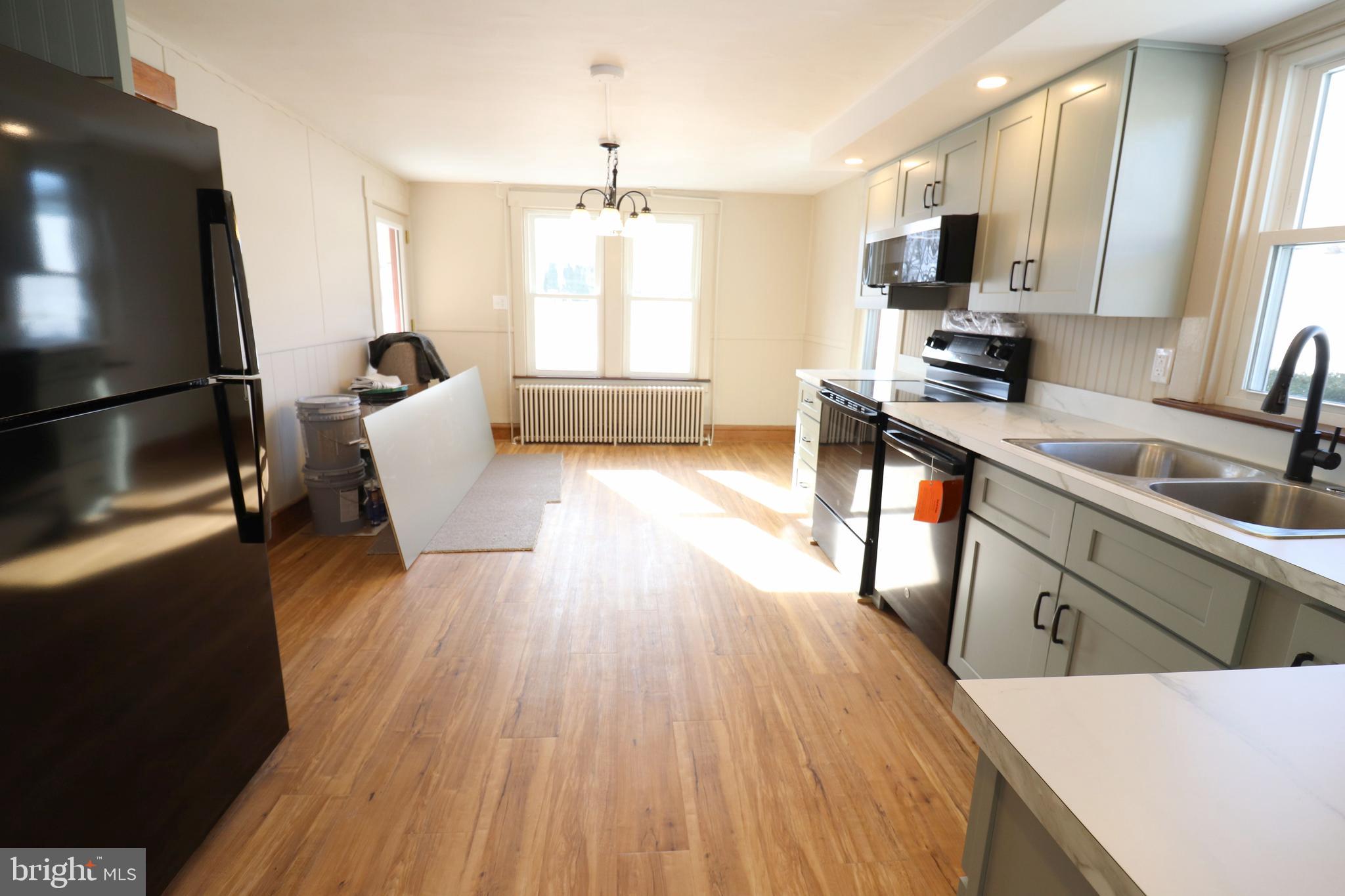 985 South Ridge Road Denver, PA 17517 - Photo 8 of 36 a kitchen with wooden floors and refrigerator