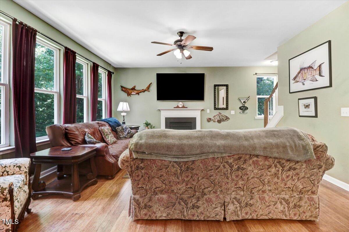 1304 Double Oak Lane Willow Spring, NC 27592 - Photo 11 of 46 a living room with furniture large window and a flat screen tv