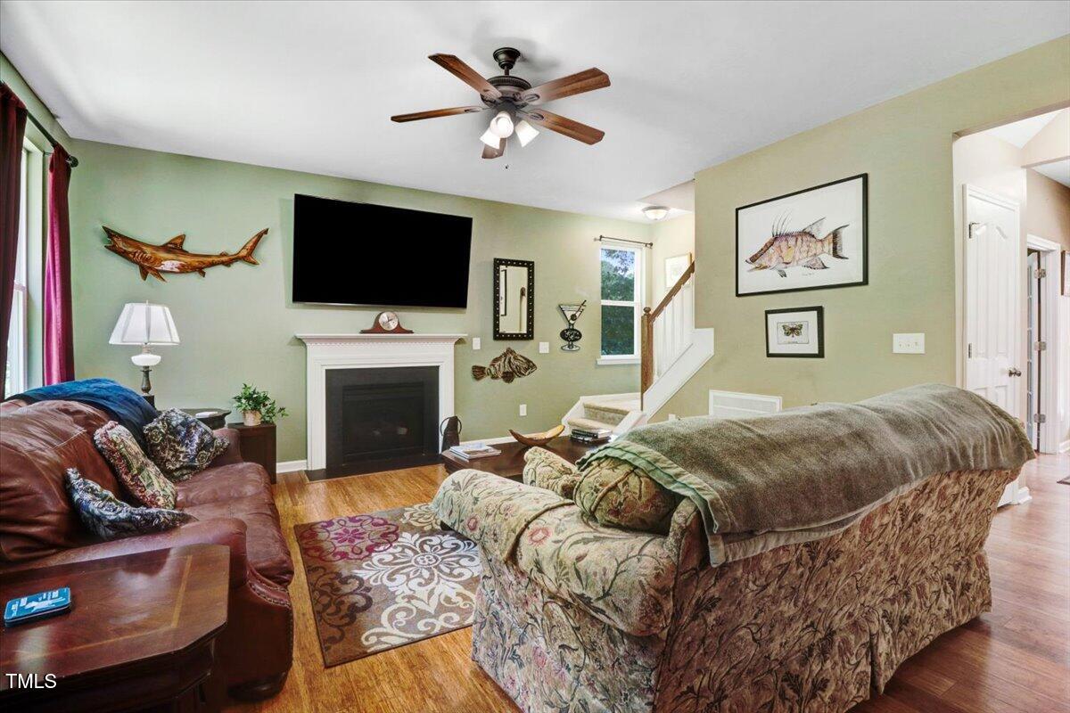 1304 Double Oak Lane Willow Spring, NC 27592 - Photo 12 of 46 a living room with furniture fireplace and a flat screen tv