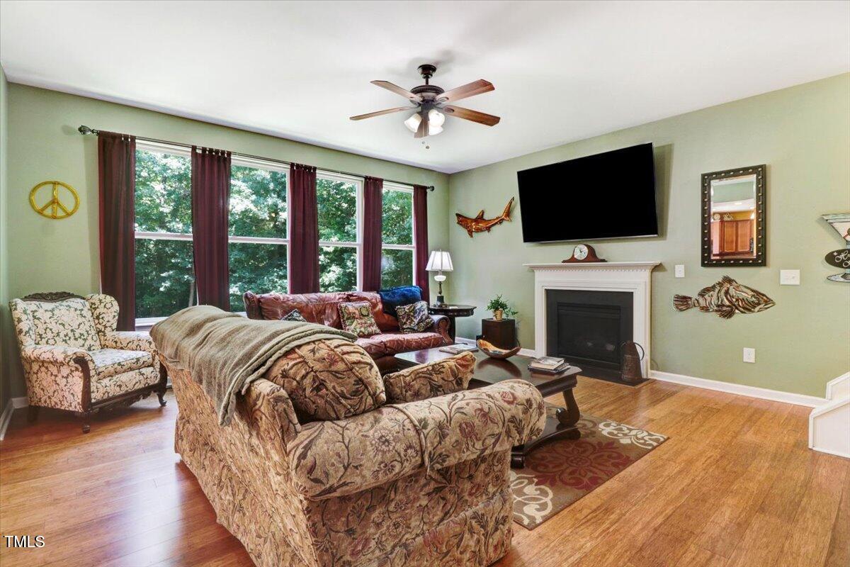 1304 Double Oak Lane Willow Spring, NC 27592 - Photo 13 of 46 a living room with furniture a fireplace and a flat screen tv