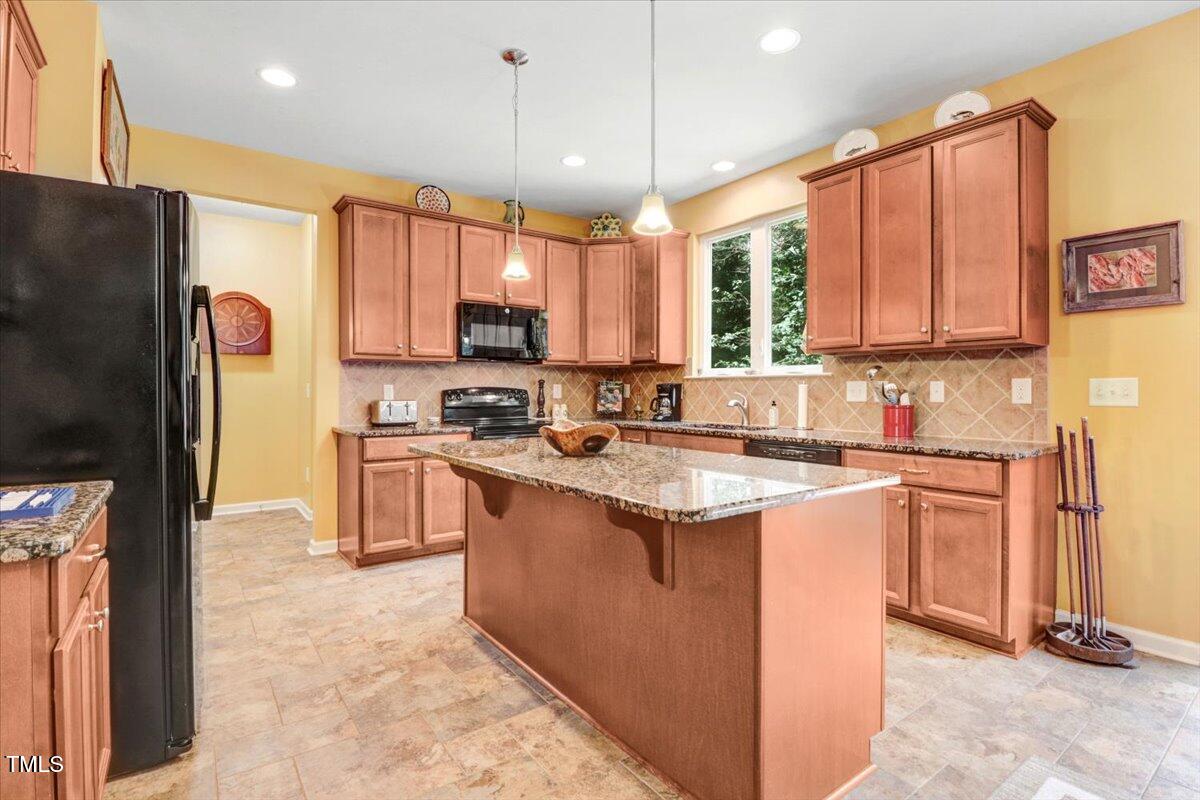 1304 Double Oak Lane Willow Spring, NC 27592 - Photo 16 of 46 a kitchen with stainless steel appliances granite countertop a refrigerator stove sink and dishwasher