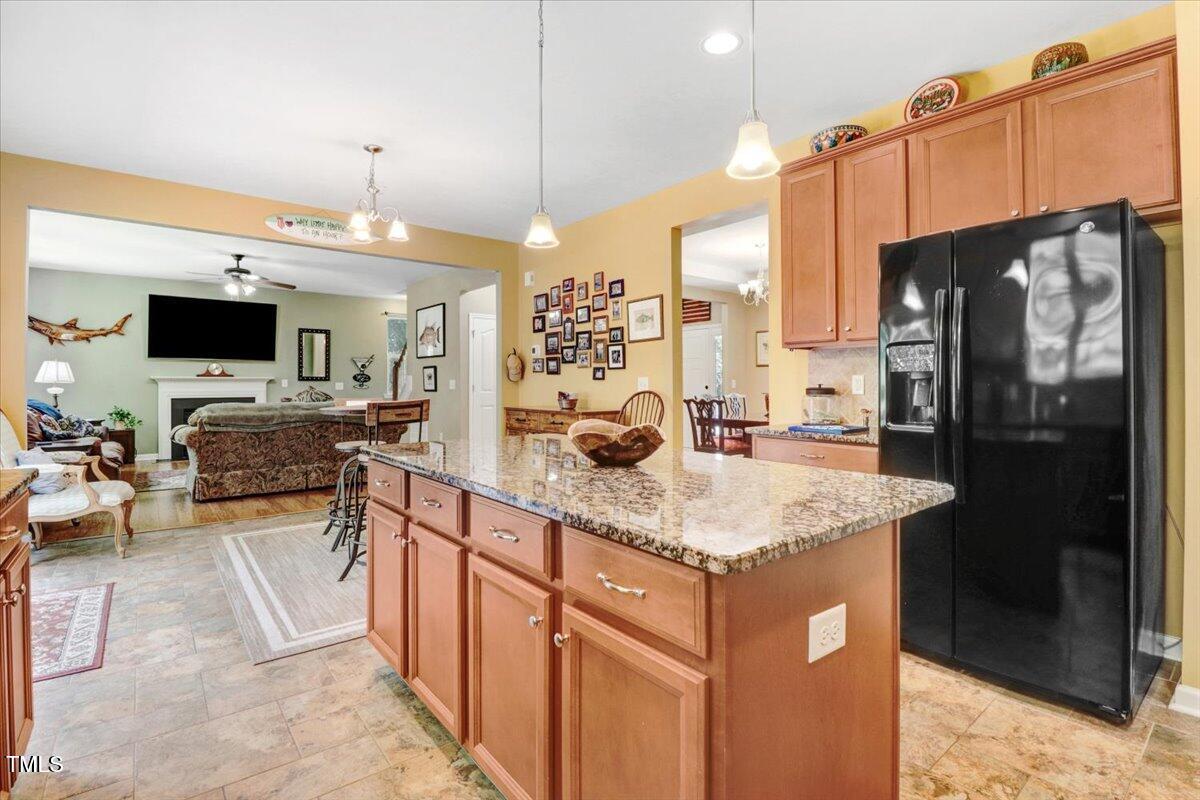 1304 Double Oak Lane Willow Spring, NC 27592 - Photo 21 of 46 a kitchen with stainless steel appliances granite countertop a sink stove and refrigerator