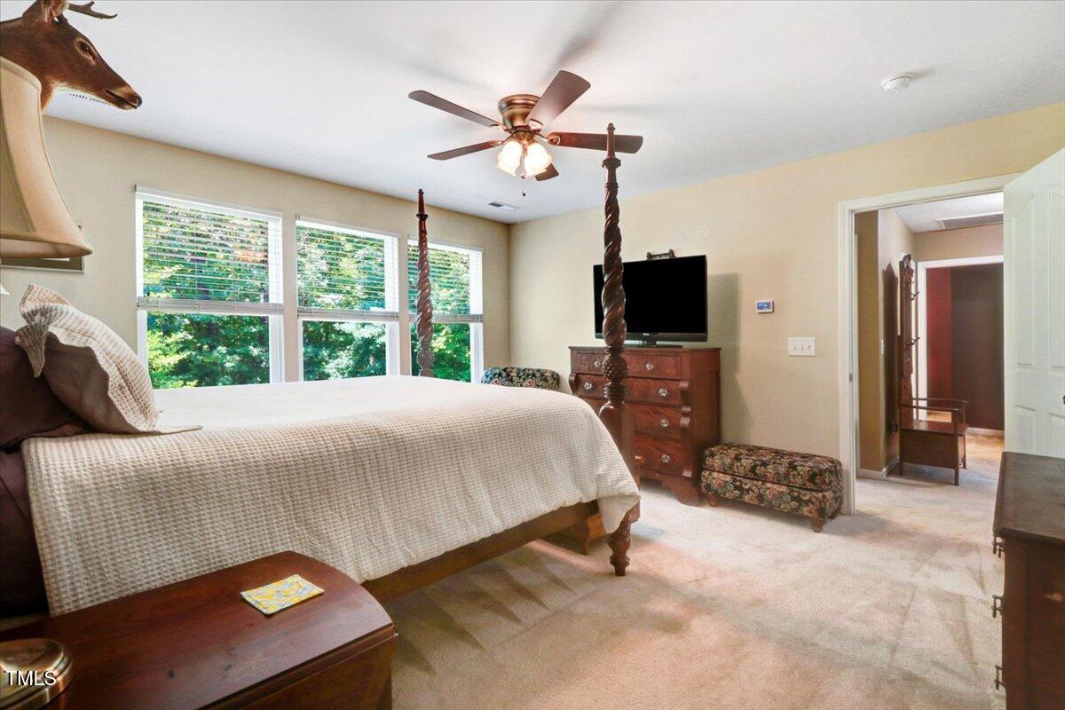 1304 Double Oak Lane Willow Spring, NC 27592 - Photo 23 of 46 a bedroom with a bed and a flat screen tv
