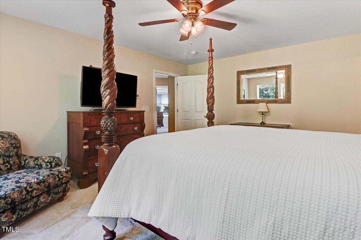 1304 Double Oak Lane Willow Spring, NC 27592 - Photo 24 of 46 a bedroom with a bed and a flat screen tv