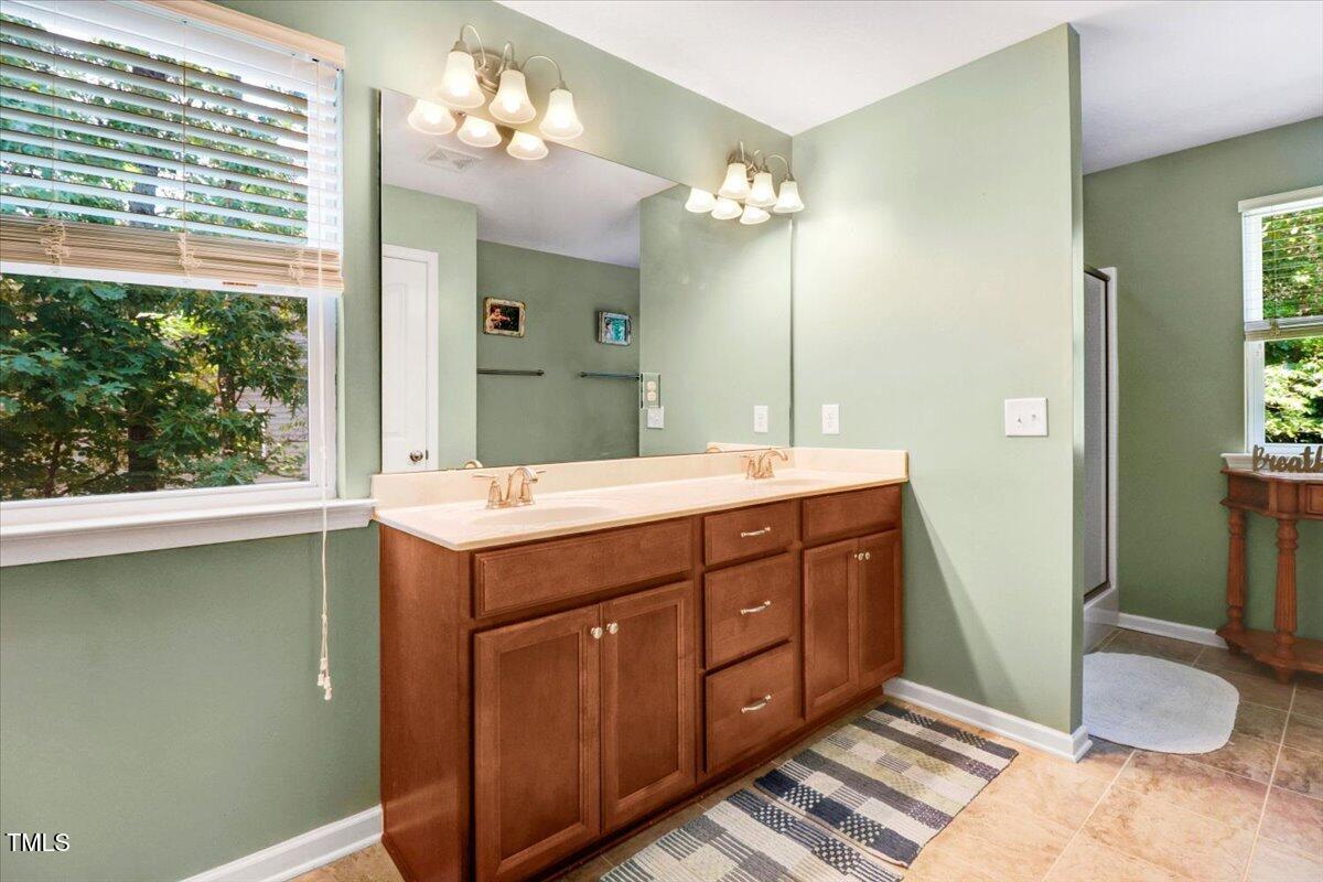 1304 Double Oak Lane Willow Spring, NC 27592 - Photo 26 of 46 a bathroom with a sink double vanity and a mirror