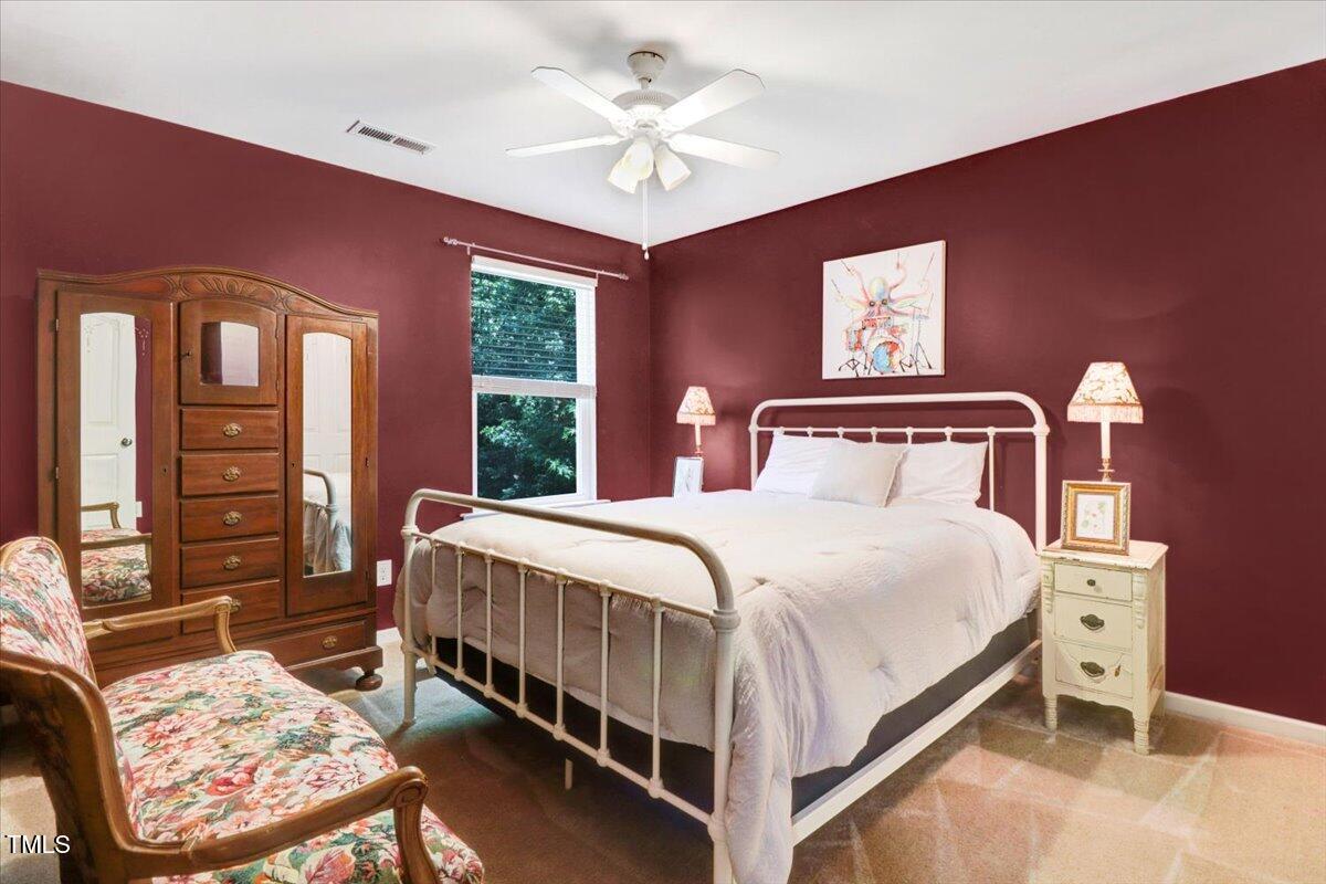 1304 Double Oak Lane Willow Spring, NC 27592 - Photo 29 of 46 a bedroom with a bed a chandelier and dresser