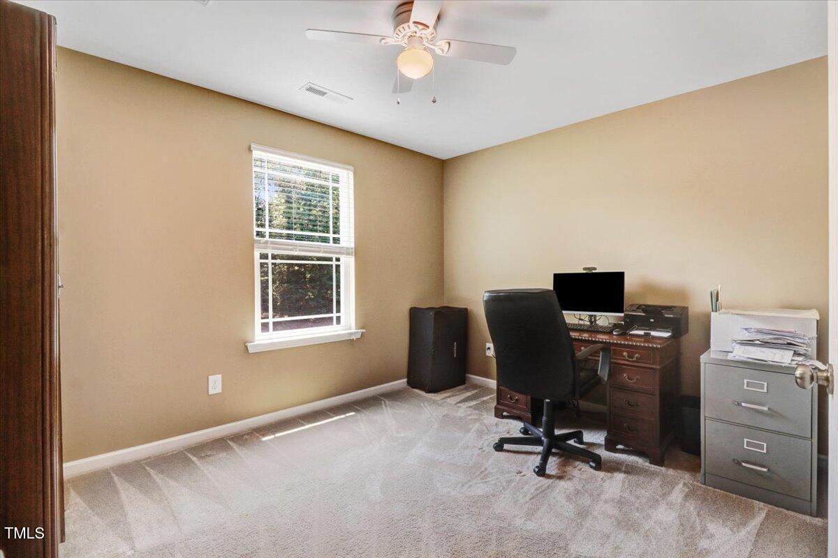 1304 Double Oak Lane Willow Spring, NC 27592 - Photo 31 of 46 a view of a workspace with furniture and a window