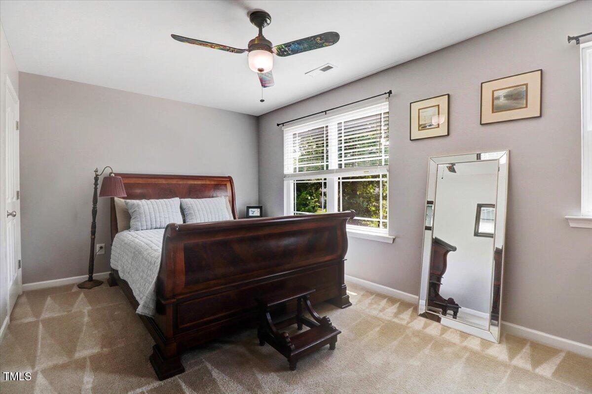 1304 Double Oak Lane Willow Spring, NC 27592 - Photo 32 of 46 a bedroom with a bed and a window