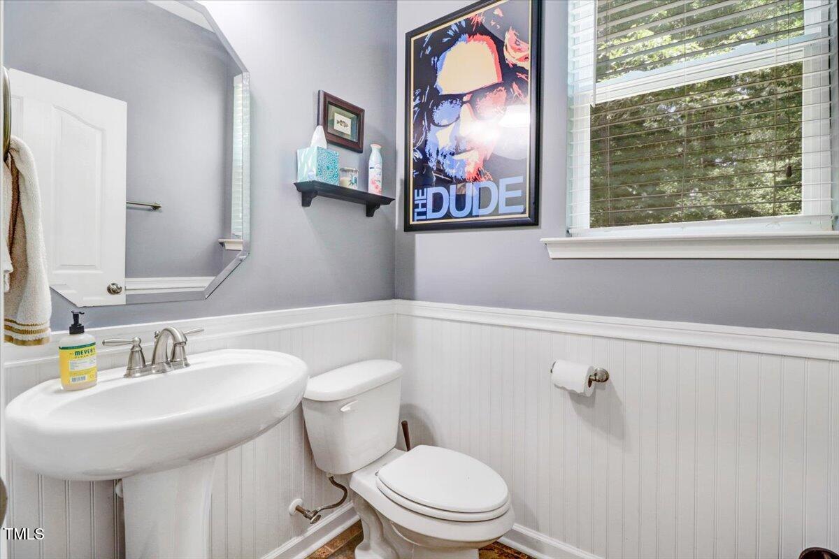 1304 Double Oak Lane Willow Spring, NC 27592 - Photo 33 of 46 a bathroom with a toilet a sink and a mirror