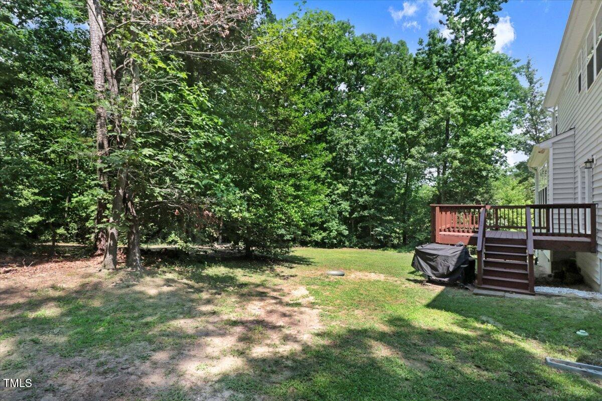 1304 Double Oak Lane Willow Spring, NC 27592 - Photo 36 of 46 a view of a backyard with wooden fence