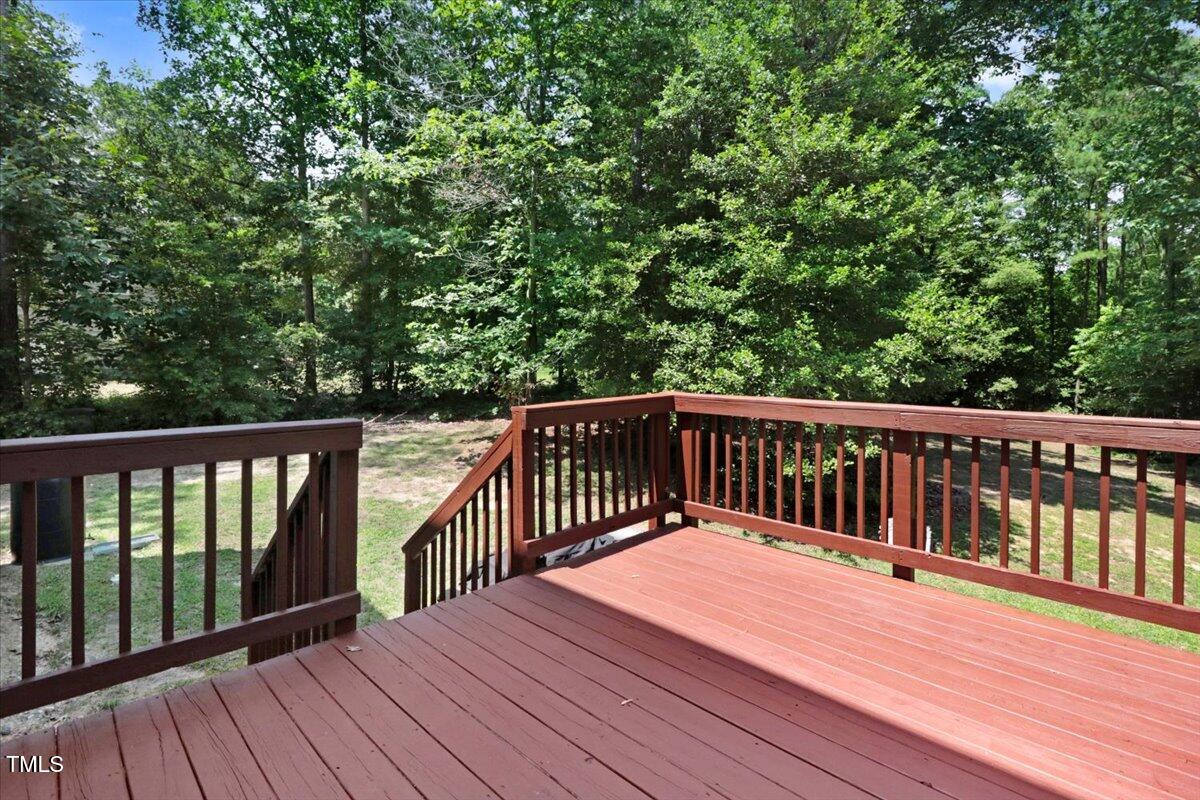 1304 Double Oak Lane Willow Spring, NC 27592 - Photo 38 of 46 a balcony with wooden floor and trees