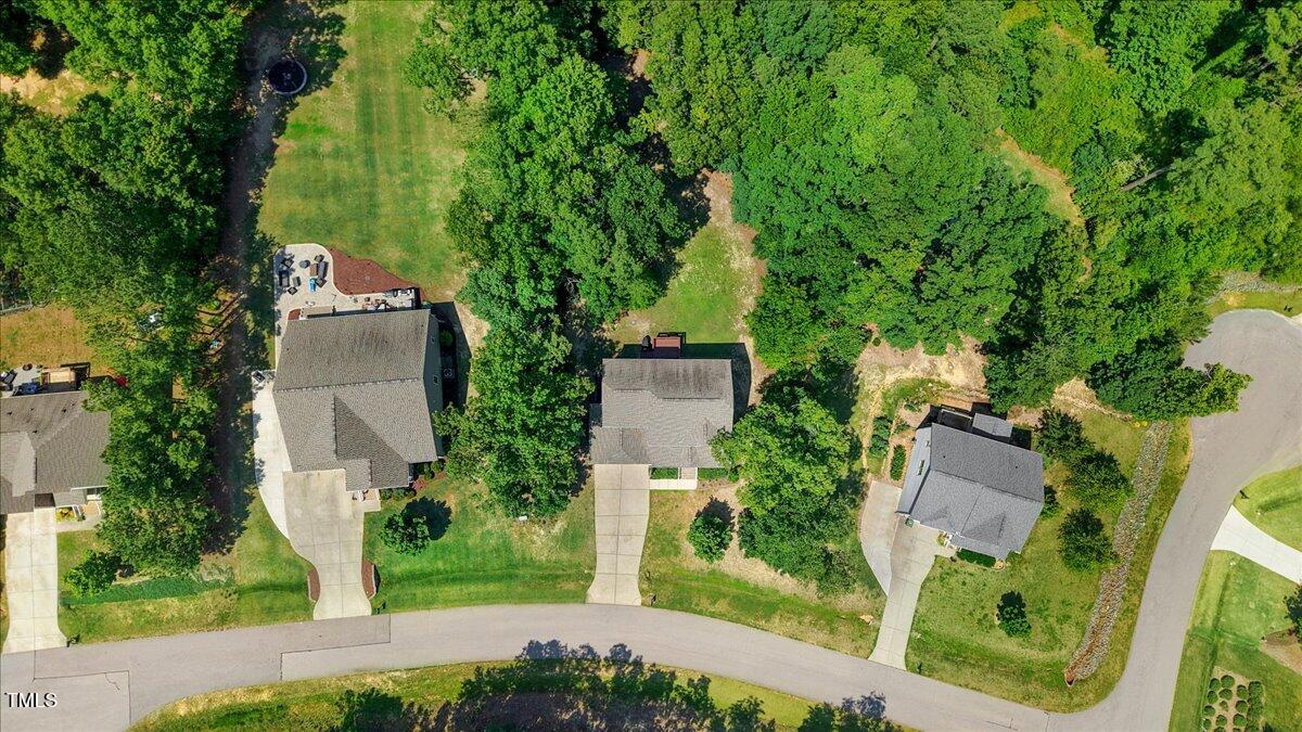 1304 Double Oak Lane Willow Spring, NC 27592 - Photo 39 of 46 an aerial view of a house with a yard and large trees