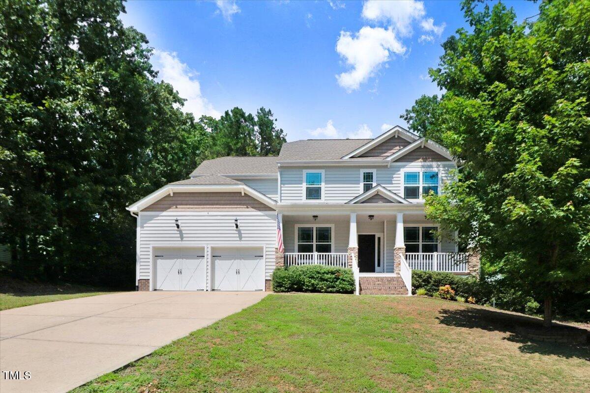 1304 Double Oak Lane Willow Spring, NC 27592 - Photo 3 of 46 a front view of a house with a yard and trees
