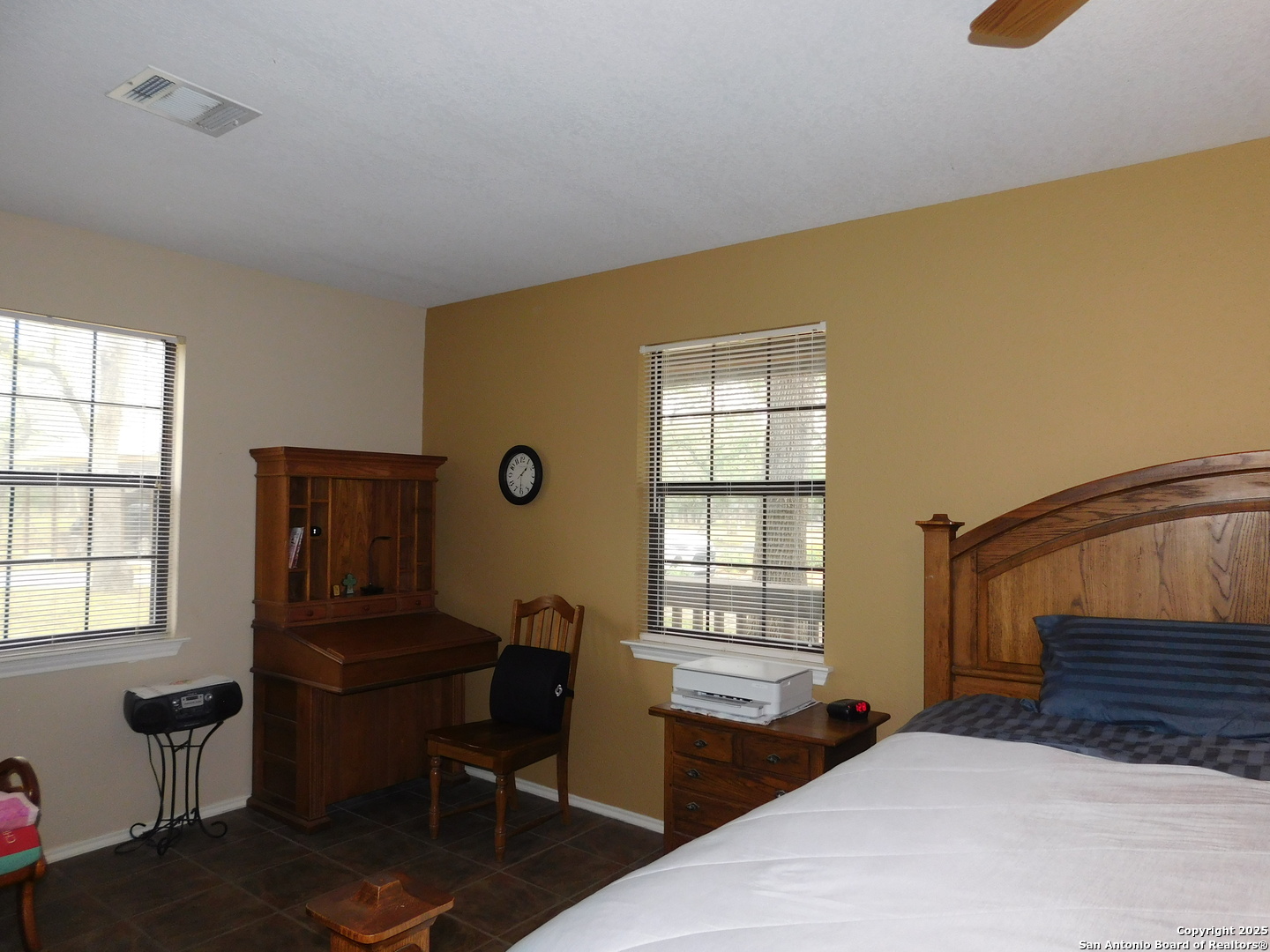 525 Cherry Ridge Floresville, TX 78114 - Photo 20 of 35 a bedroom with a bed and wooden floor