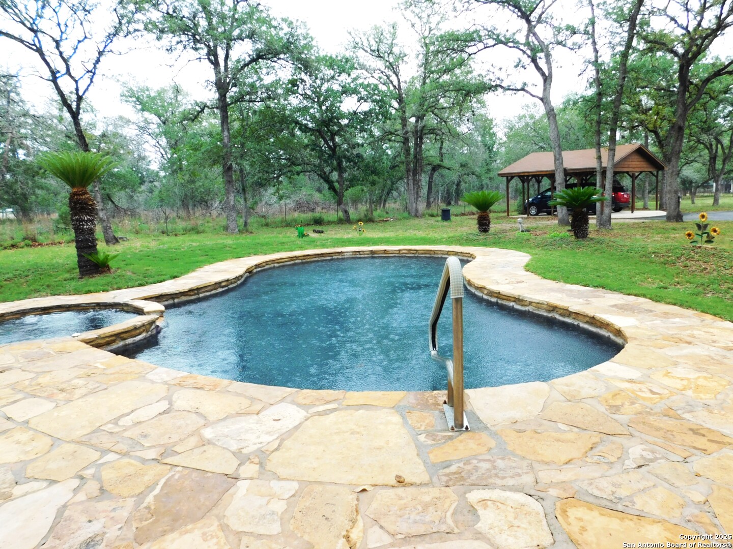 525 Cherry Ridge Floresville, TX 78114 - Photo 28 of 35 a view of a swimming pool with a patio