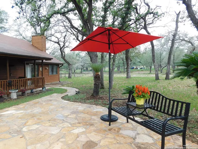 a view of a chairs and table in backyard of the house