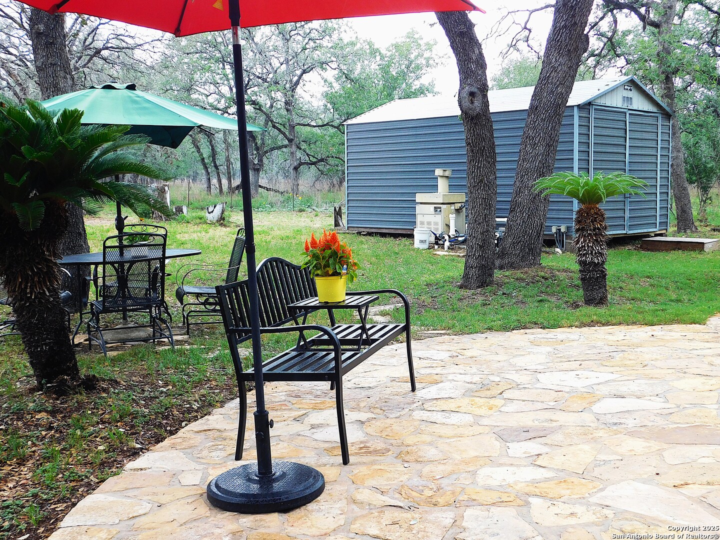 525 Cherry Ridge Floresville, TX 78114 - Photo 31 of 35 a view of a chairs and table in backyard of the house