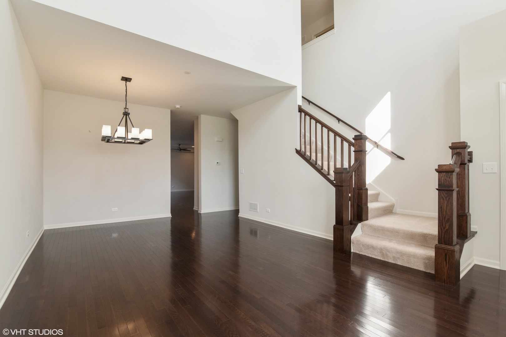 1950 Shermer Road Glenview, IL 60026 - Photo 2 of 10 a view of a hallway with wooden floor and staircase
