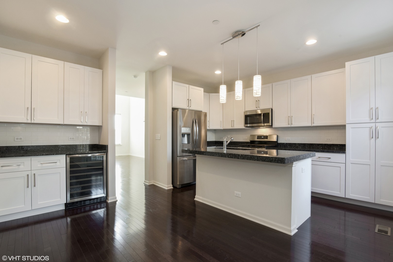 1950 Shermer Road Glenview, IL 60026 - Photo 3 of 10 a kitchen with stainless steel appliances granite countertop a refrigerator a sink dishwasher a stove and white cabinets with wooden floor