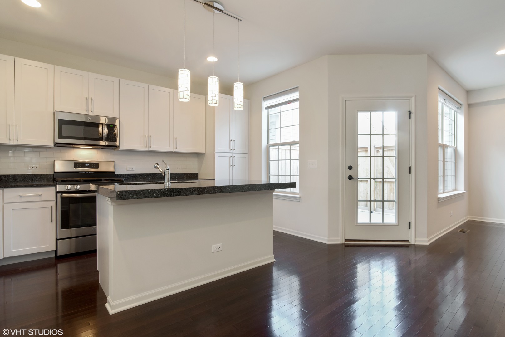 1950 Shermer Road Glenview, IL 60026 - Photo 4 of 10 a kitchen with stainless steel appliances granite countertop a stove a sink and a microwave