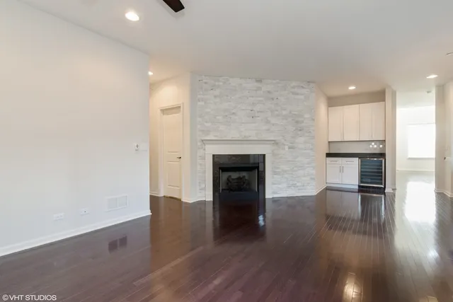 an empty room with wooden floor and fireplace