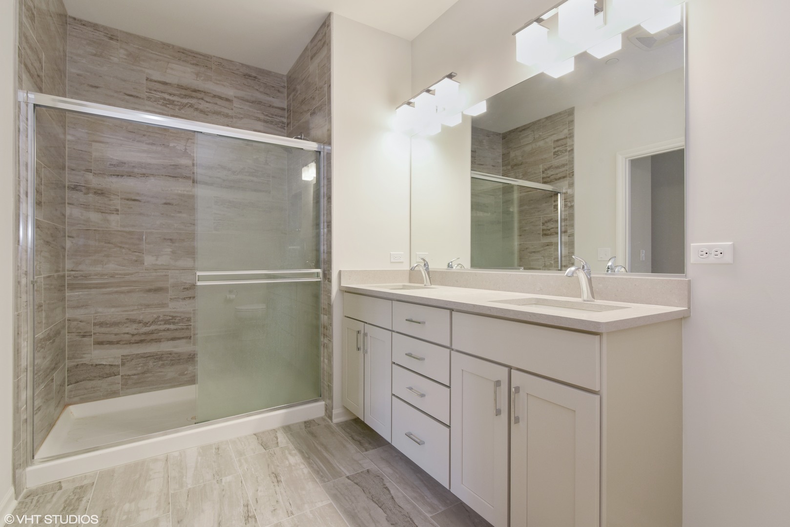 1950 Shermer Road Glenview, IL 60026 - Photo 8 of 10 a bathroom with a shower sink and mirror