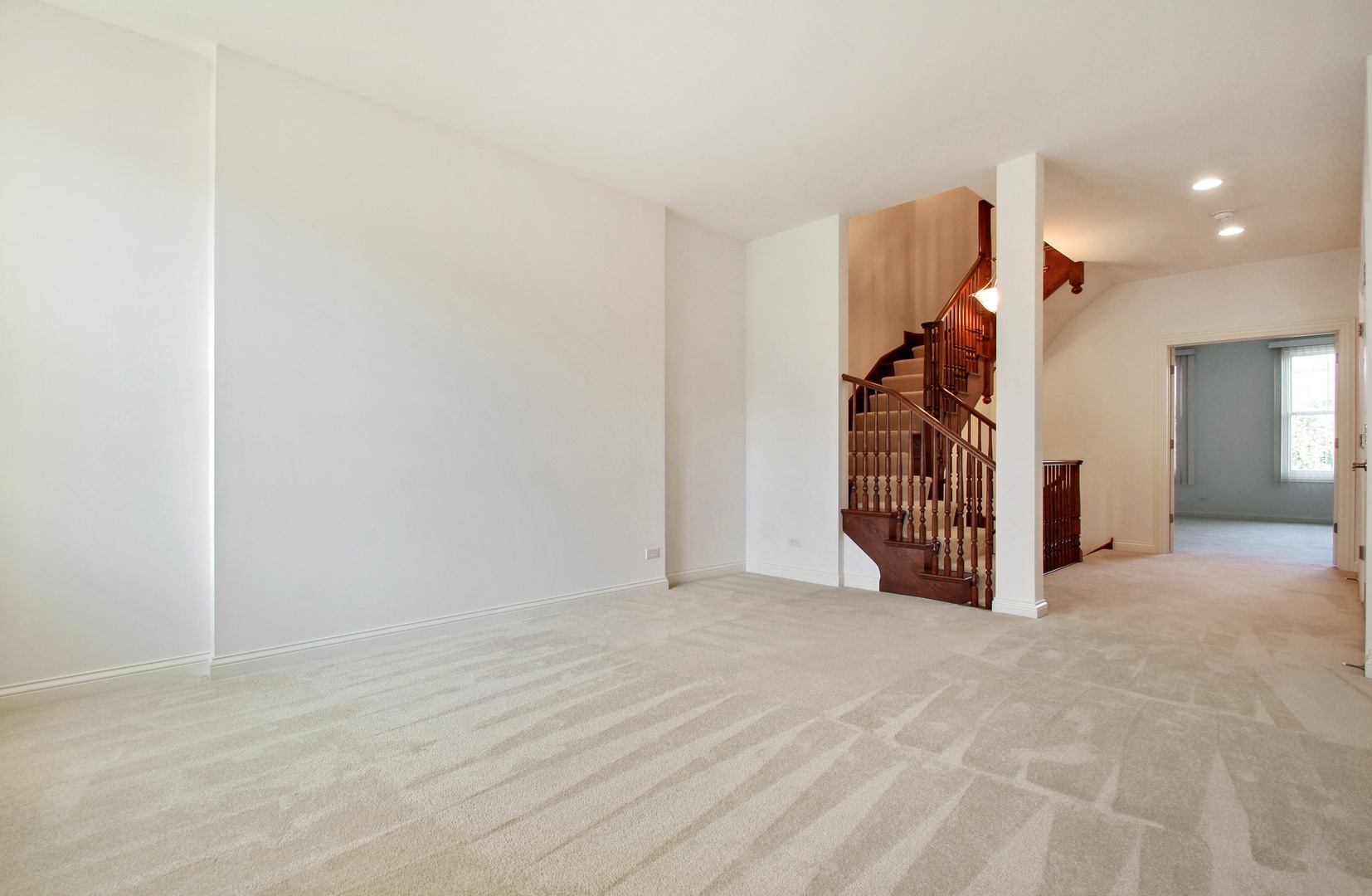 1802 Admiral Court Glenview, IL 60026 - Photo 13 of 18 a view of an empty room with stairs and a ceiling fan