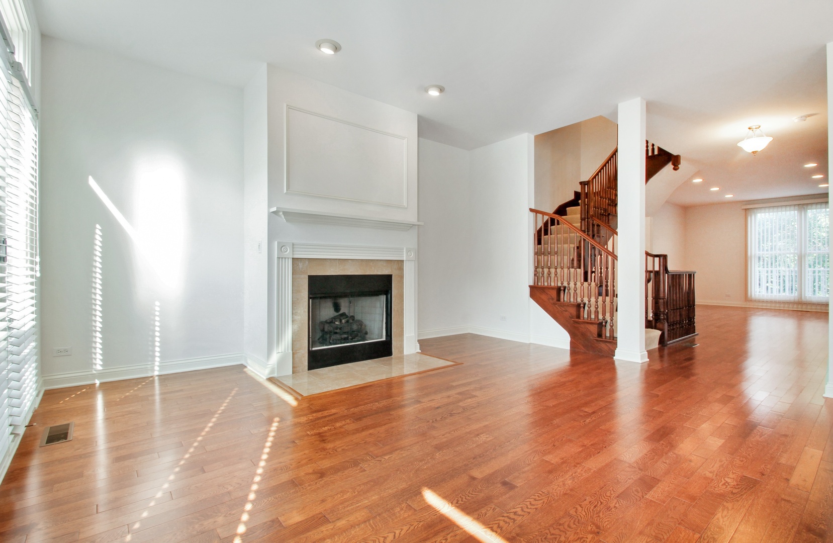 1802 Admiral Court Glenview, IL 60026 - Photo 7 of 18 a view of a livingroom with wooden floor and a fireplace