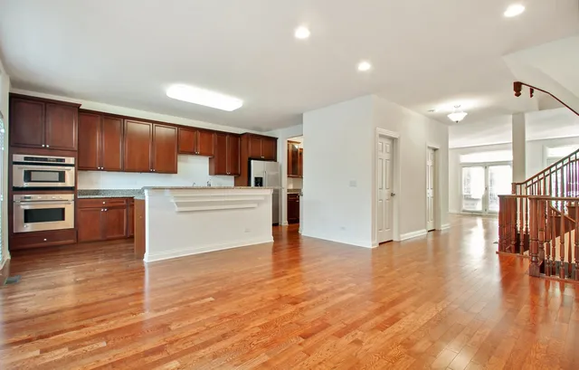 a kitchen with stainless steel appliances a refrigerator and a stove top oven
