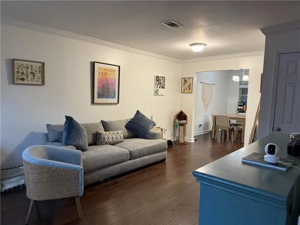 a living room with furniture and wooden floor