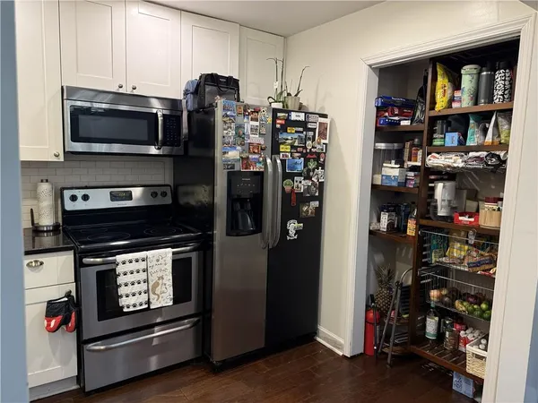 a kitchen with stainless steel appliances a stove a refrigerator and a window