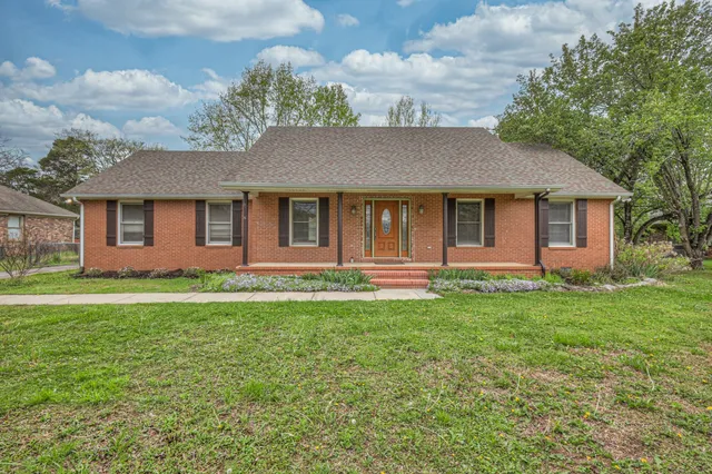 a front view of a house with a garden