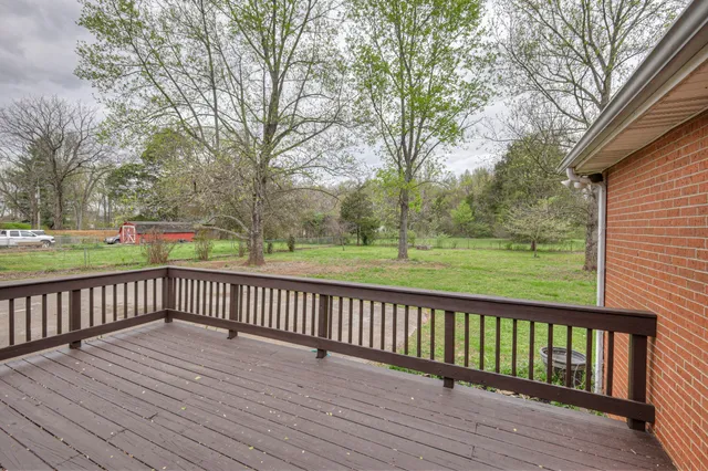 a view of deck with wooden floor and fence