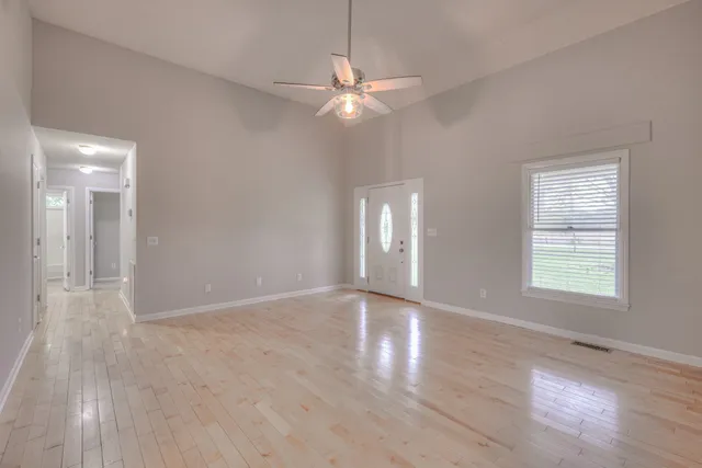 wooden floor in an empty room with a window