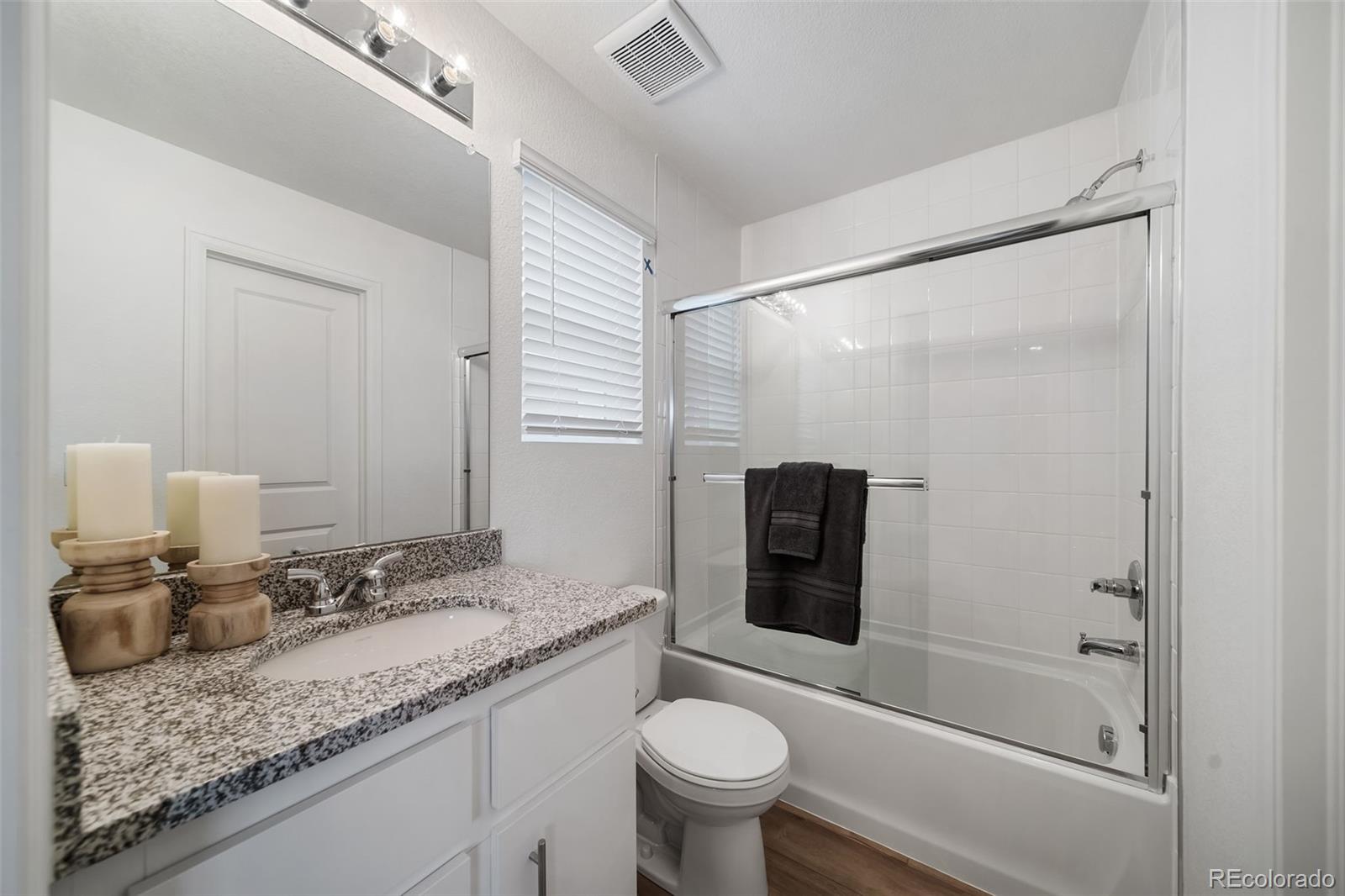 3372 Baltin Road Johnstown, CO 80534 - Photo 18 of 24 a bathroom with a granite countertop sink toilet and shower