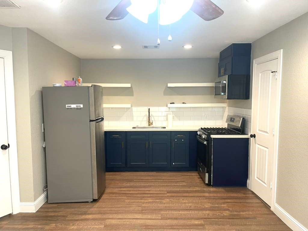 3807 Edison Street Houston, TX 77009 - Photo 3 of 11 a kitchen with stainless steel appliances granite countertop a refrigerator and a sink