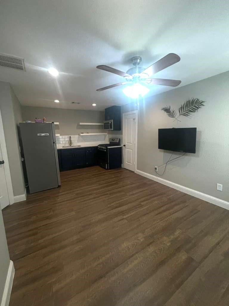 3807 Edison Street Houston, TX 77009 - Photo 5 of 11 a view of kitchen and empty room with wooden floor