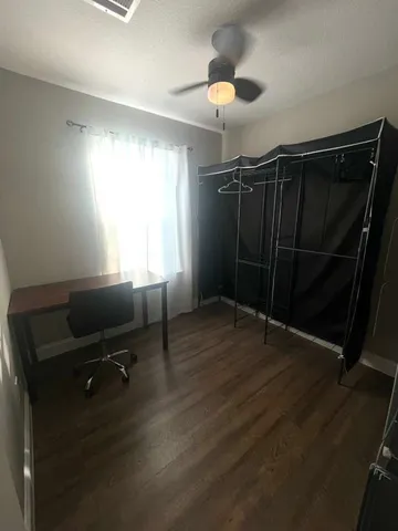 a view of a room with wooden floor and windows