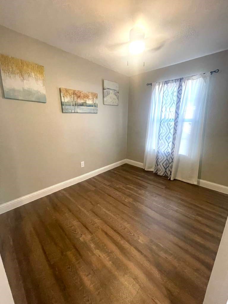 3807 Edison Street Houston, TX 77009 - Photo 7 of 11 a view of empty room with wooden floor and fan