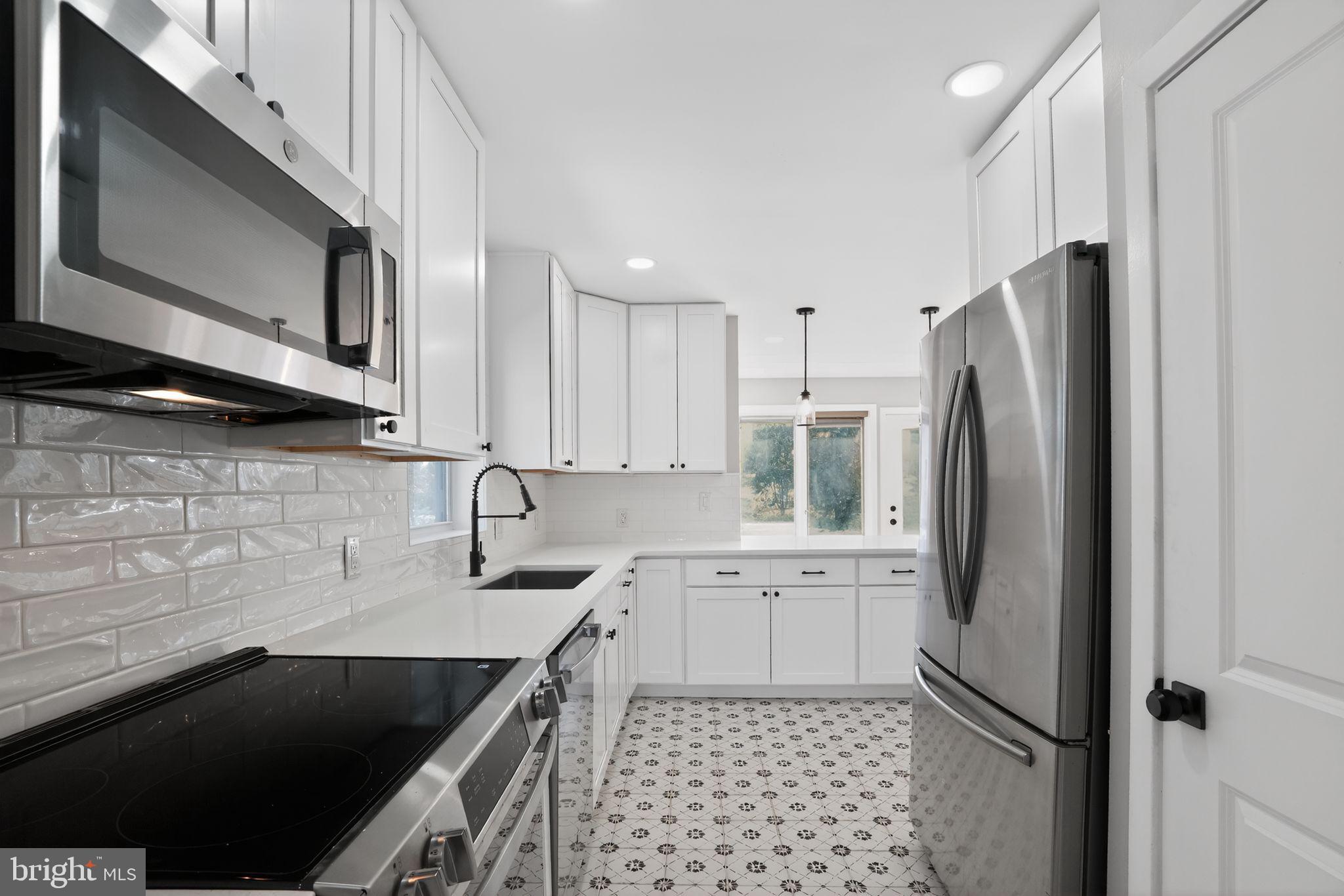 99 Rorer Street Glenside, PA 19038 - Photo 11 of 36 a kitchen with a sink stove and refrigerator