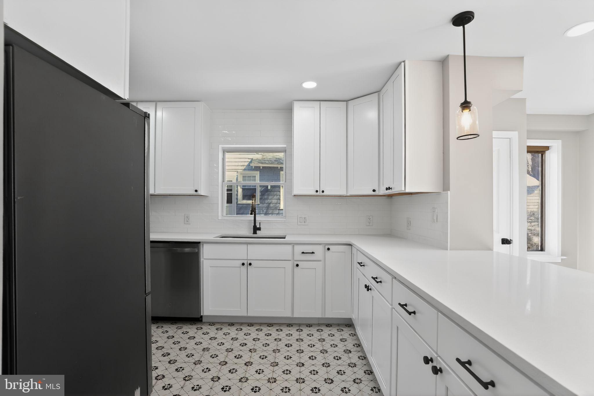 99 Rorer Street Glenside, PA 19038 - Photo 12 of 36 a kitchen with white cabinets sink and dishwasher