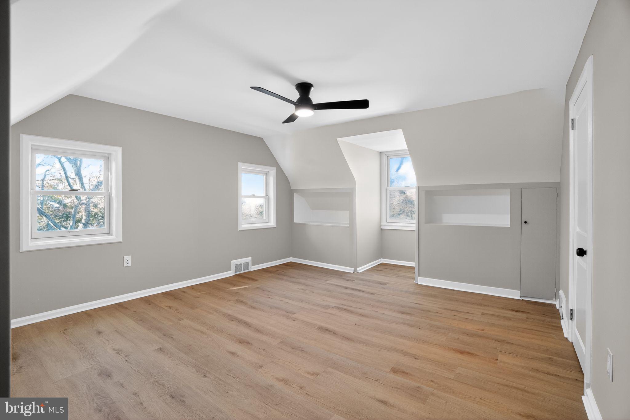 99 Rorer Street Glenside, PA 19038 - Photo 24 of 36 an empty room with wooden floor ceiling fan and windows