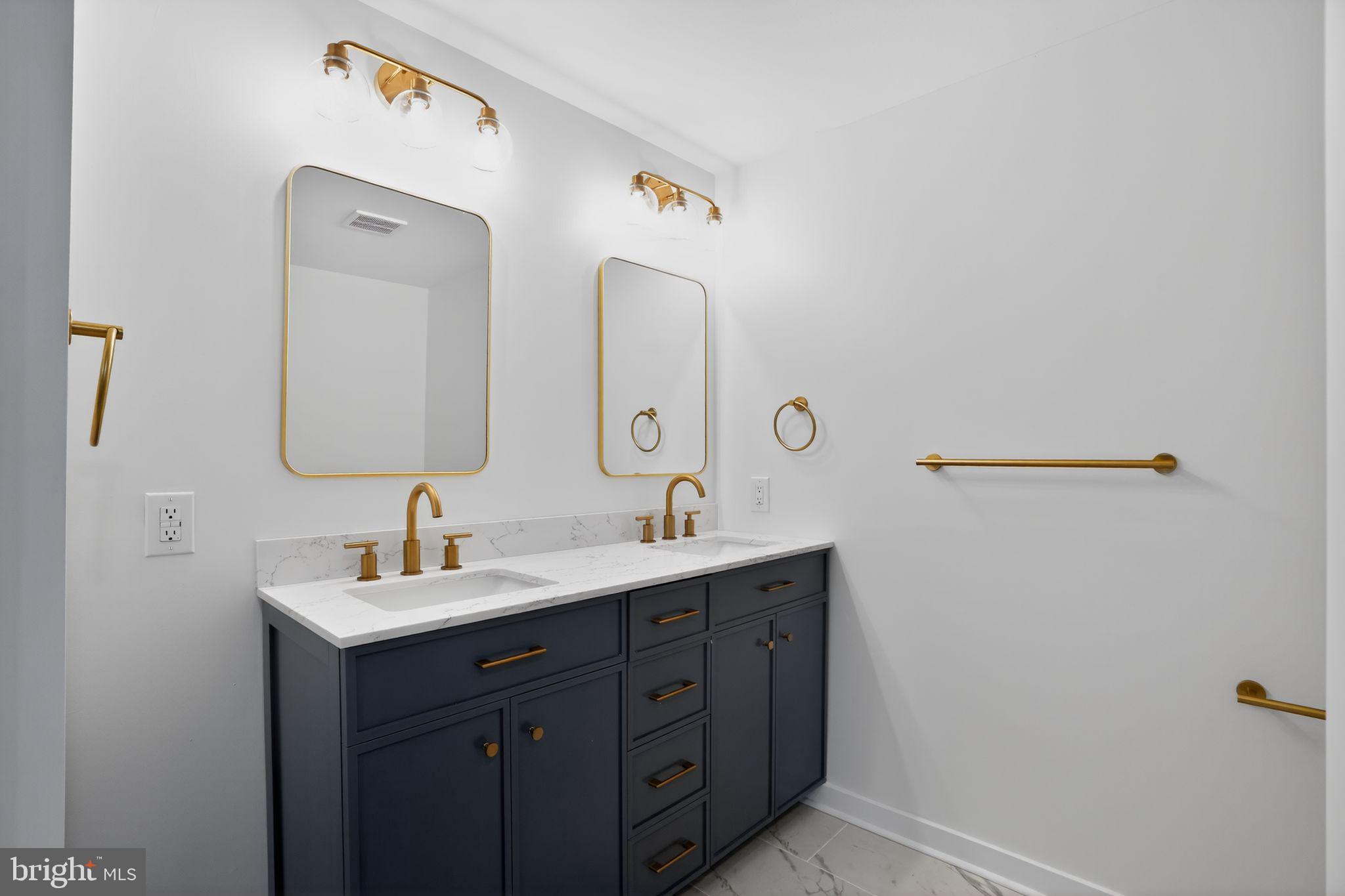 99 Rorer Street Glenside, PA 19038 - Photo 27 of 36 a bathroom with a double vanity sink and mirror