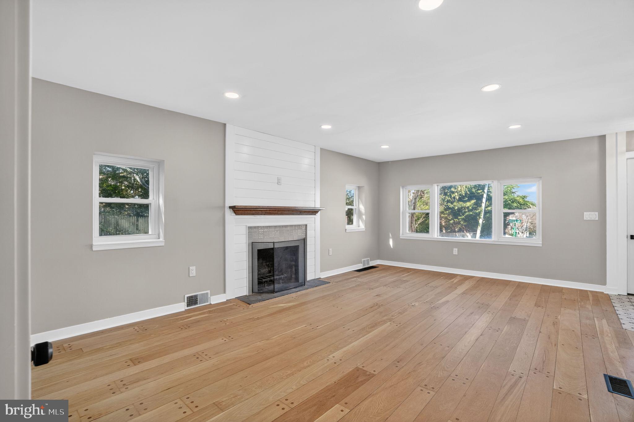 99 Rorer Street Glenside, PA 19038 - Photo 5 of 36 a view of empty room with wooden floor and fireplace