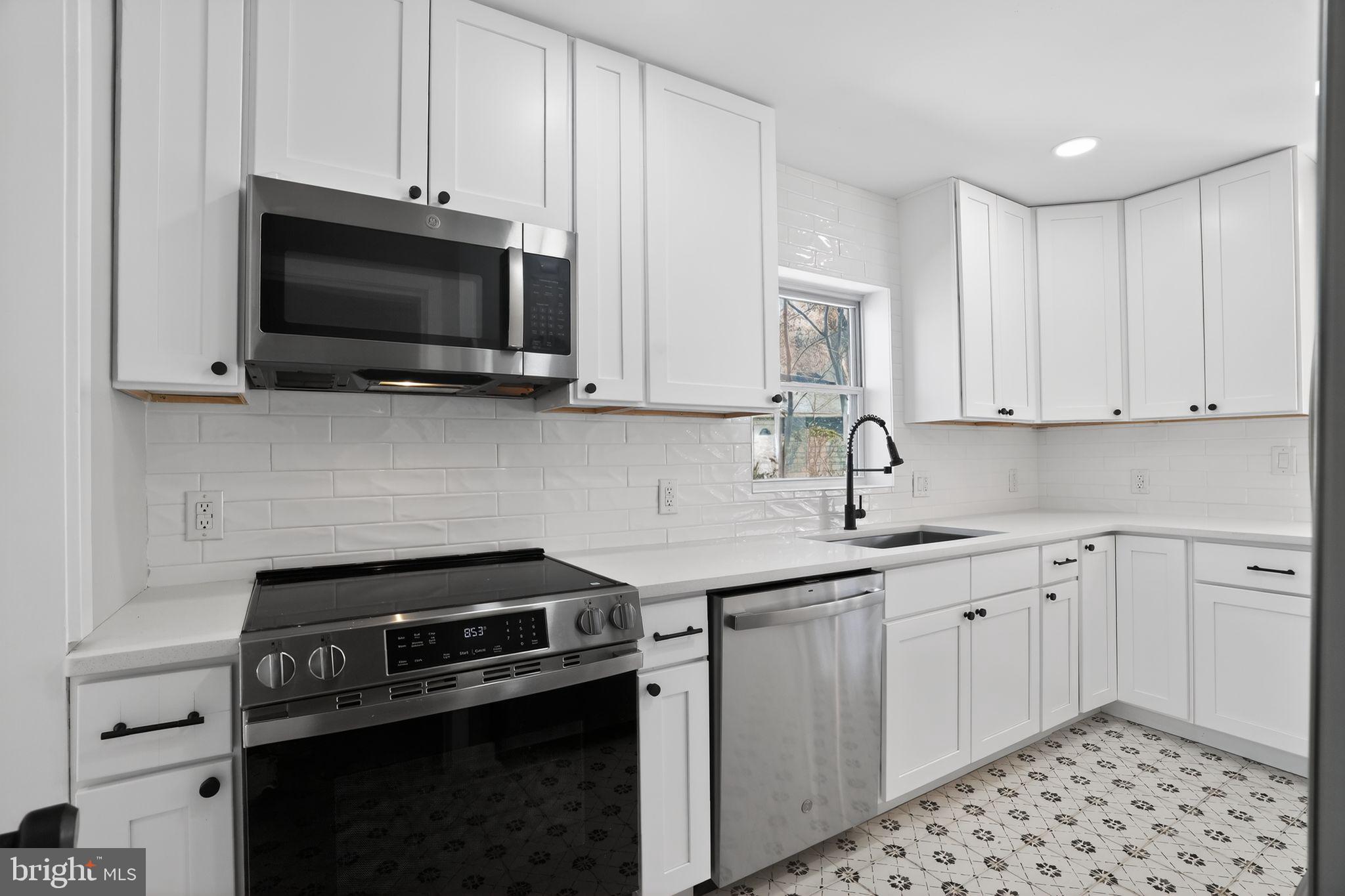 99 Rorer Street Glenside, PA 19038 - Photo 10 of 36 a kitchen with a sink stove and microwave